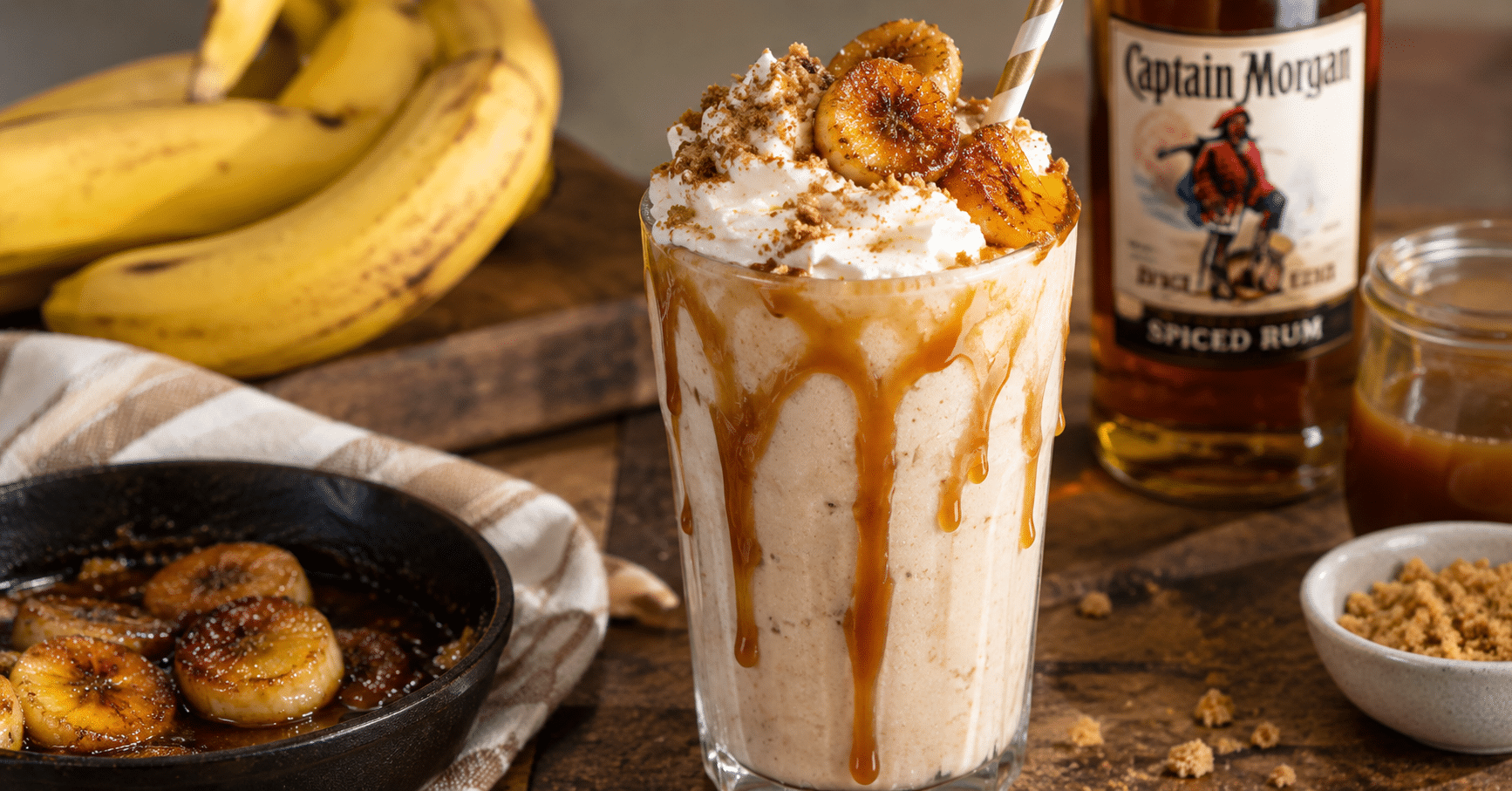 Boozy caramelized banana milkshake with rum, whipped cream, caramel sauce, and caramelized bananas